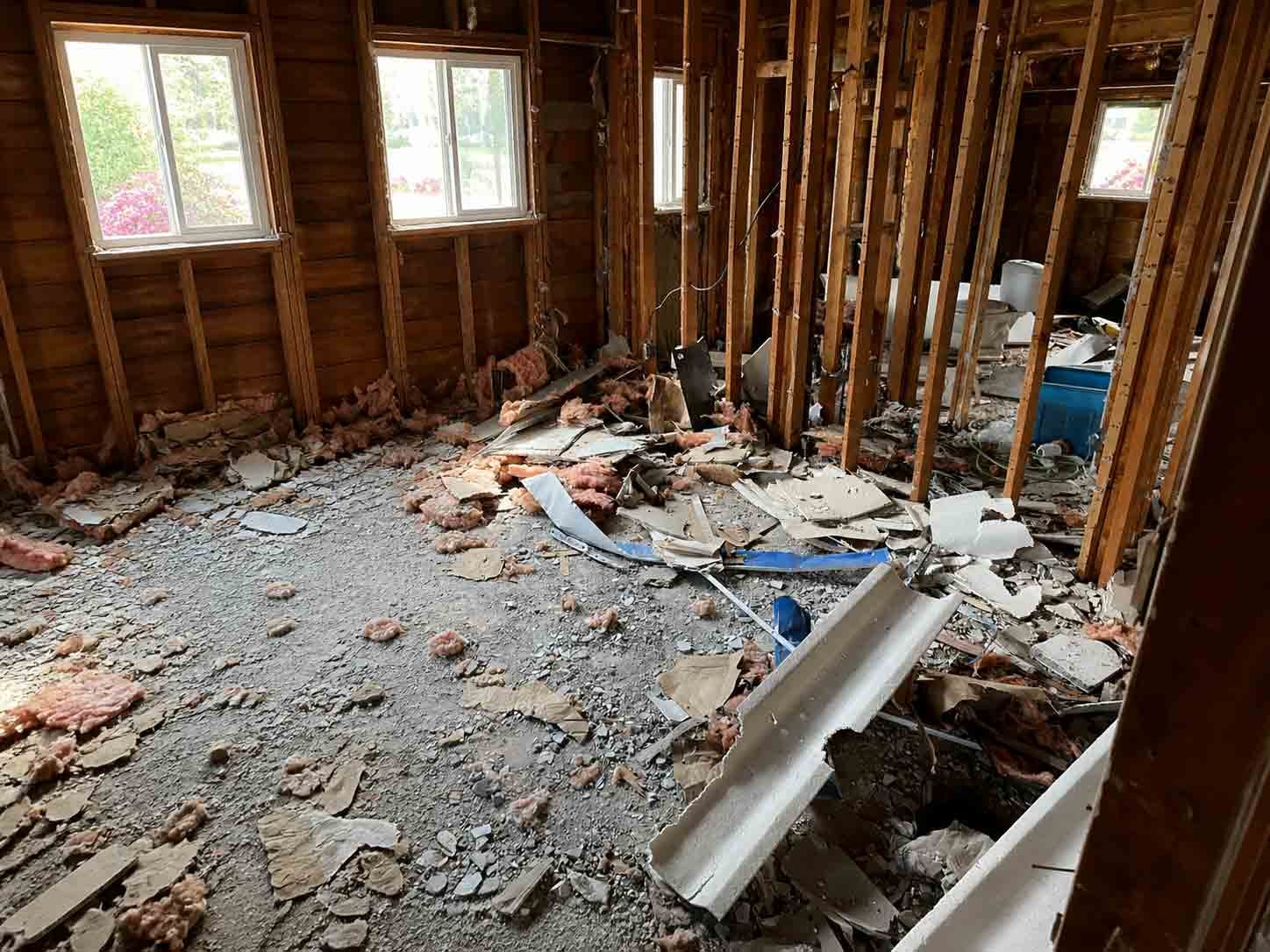 Interior demolition debris scattered on the floor before cleanup by Turbo Haul Disposal