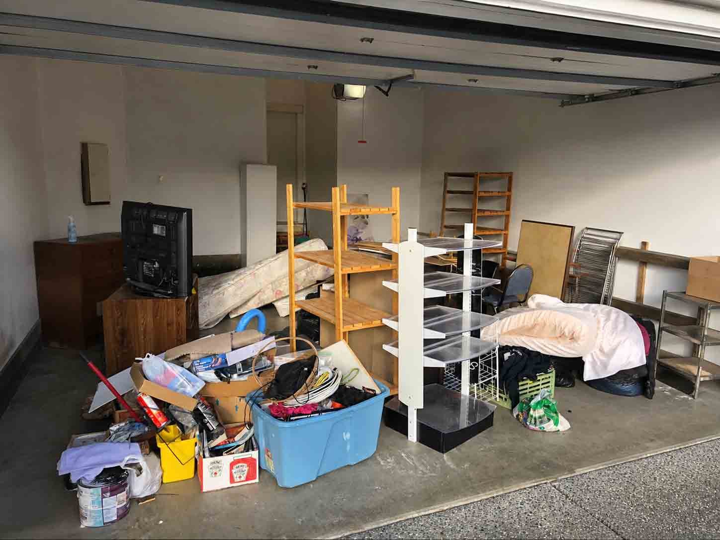 Cluttered residential garage before junk removal metro vancouver by Turbo Haul Disposal
