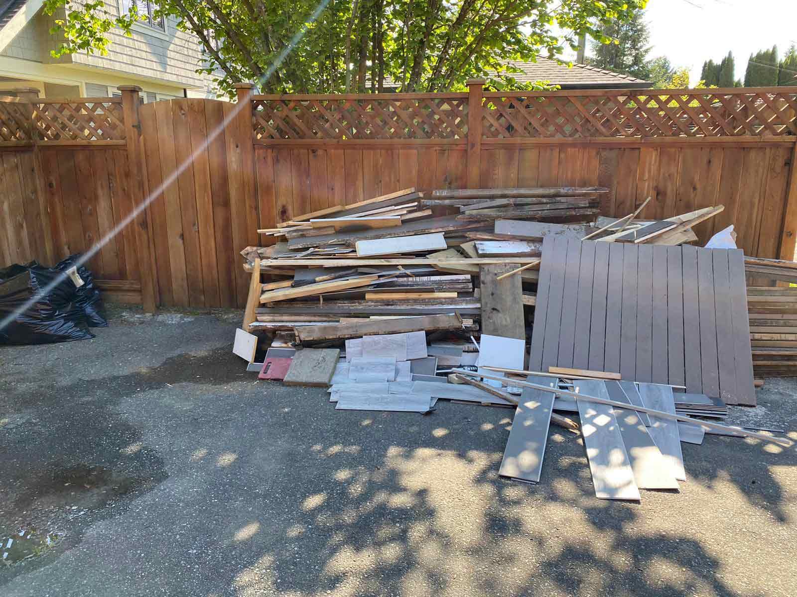 Pile of wood, flooring, and Renovation debris cleanup and junk removal Metro Vancouver by Turbo Haul Disposal