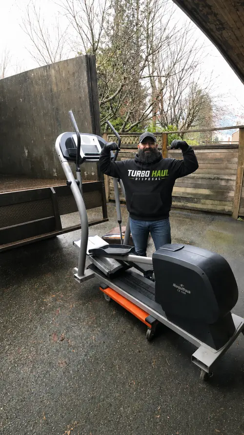 Turbo Haul team member removing a large elliptical machine in Metro Vancouver