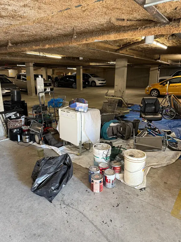 Dishwasher with furniture and mixed junk prepared for property cleanout